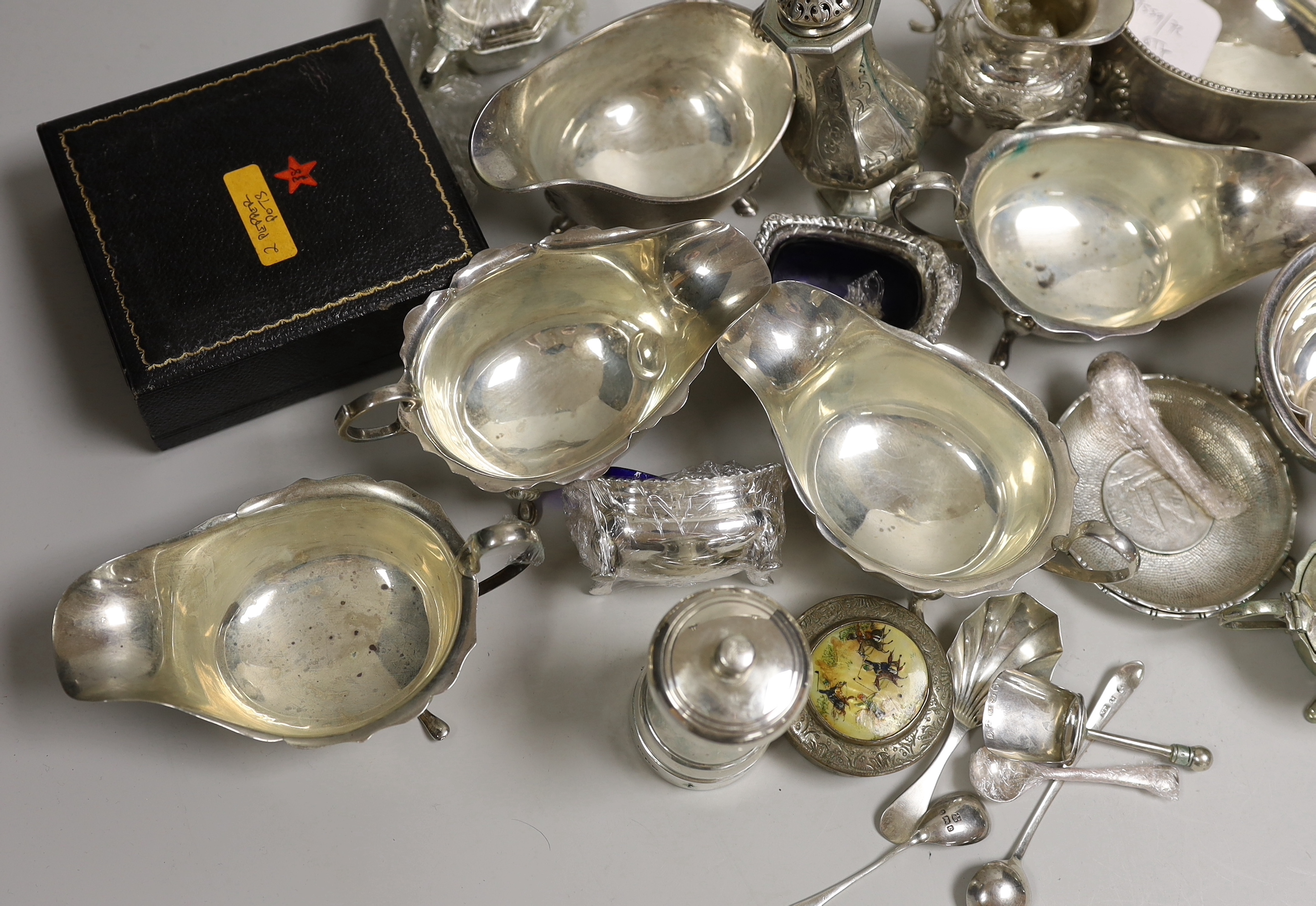 A mixed collection of small silver and plated items to include five various sauceboats, a cased pair of pepper pots, a chased Victorian sugar sifter, two caddy spoons, a silver mounted peppermill, two Chinese coin-set tr